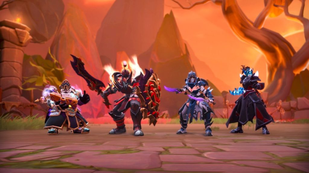 Quatre personnages héros de jeu vidéo debout en équipe devant un décor fantastique, chacun portant des armures distinctes et des armes variées.