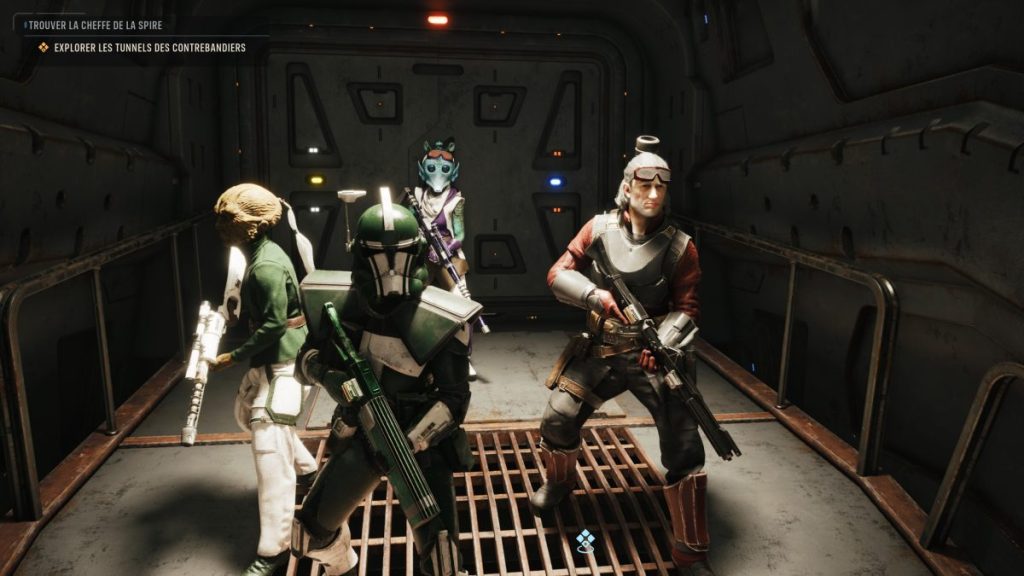 Quatre personnages d'un jeu vidéo, armés et en tenue futuriste, se tiennent dans un couloir sombre d'un vaisseau spatial.