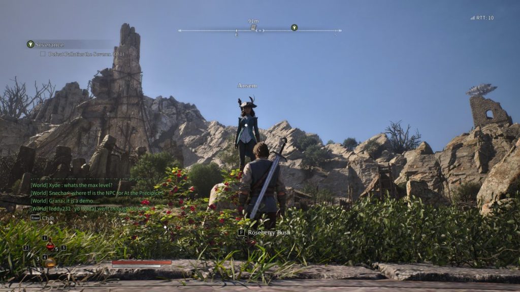 Un personnage de jeu vidéo se tient sur une plateforme au milieu de paysages rocheux avec des bâtiments en ruine en arrière-plan, sous un ciel bleu clair.